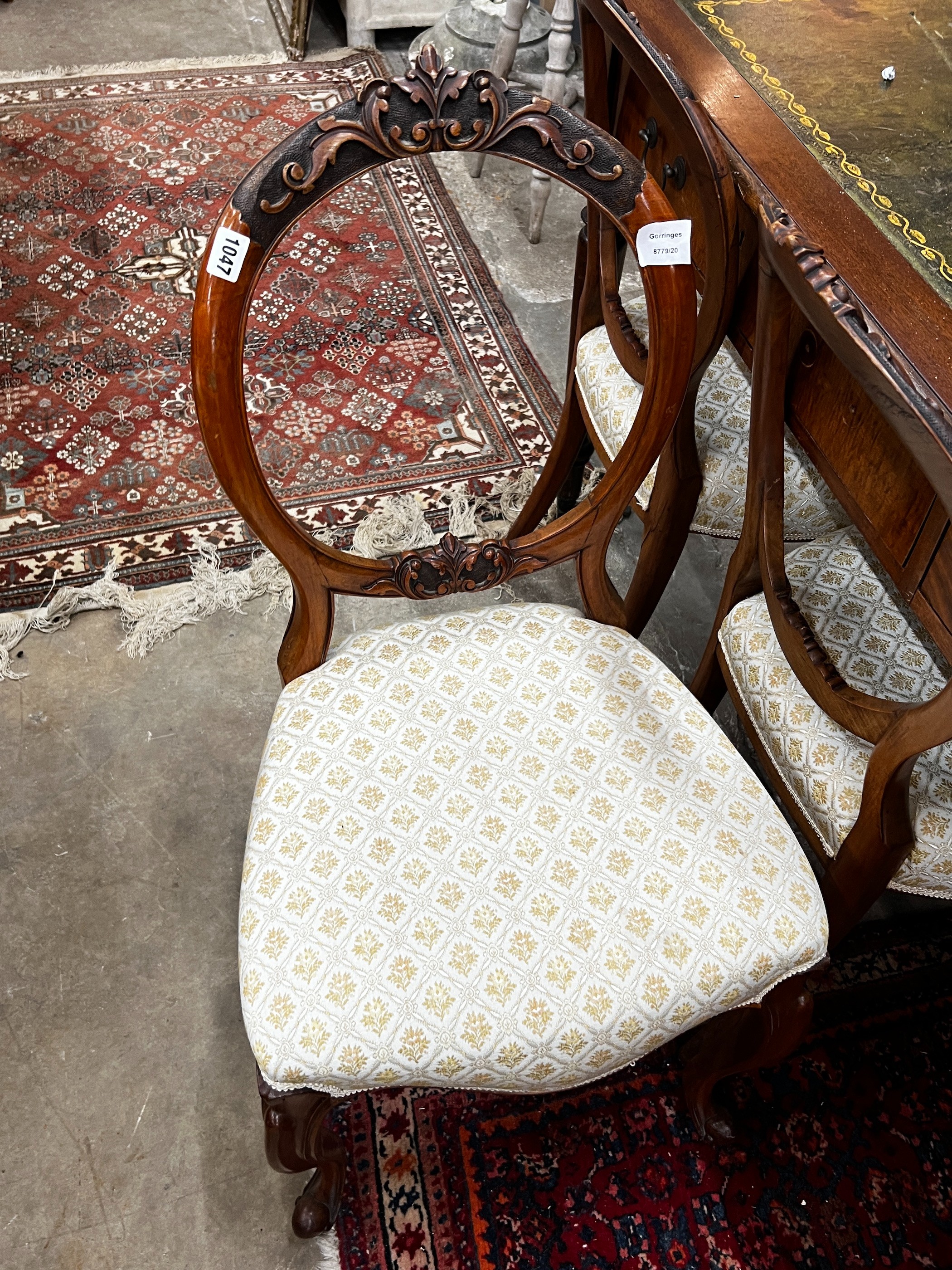 A set of six Victorian walnut balloon back dining chairs